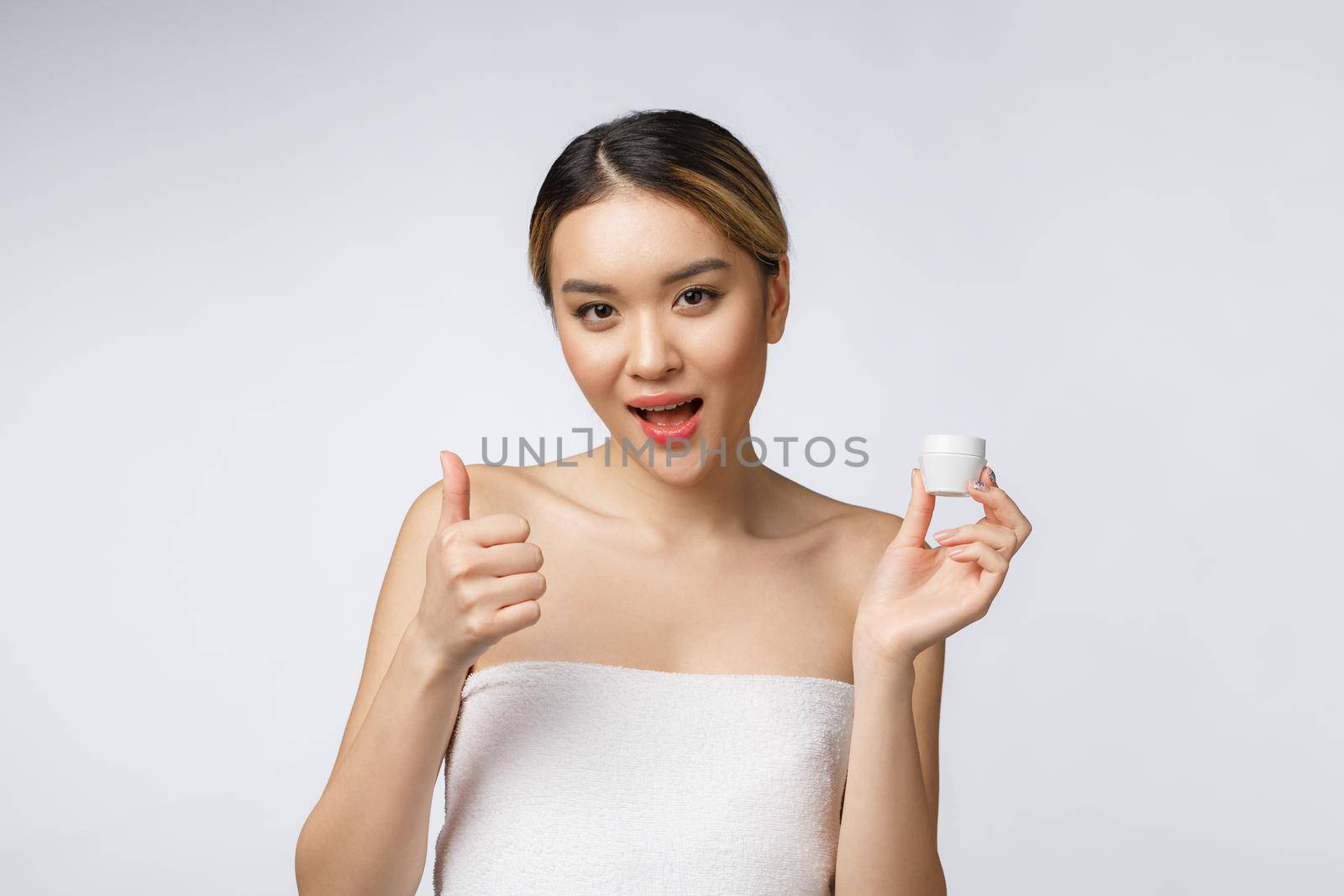 beauty asian woman thumbs up for good facial product. isolated on white background. beauty and fashion concept. by Benzoix