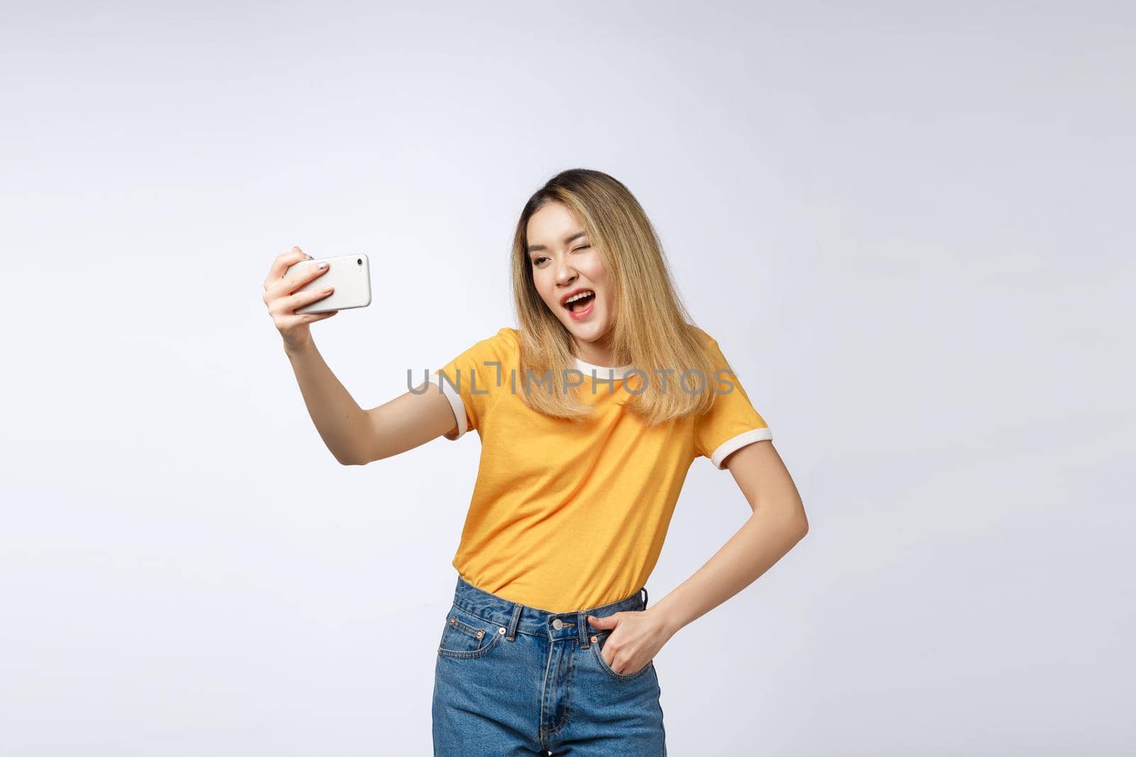 Close-up of young Asian beautiful woman taking selfie. Isolated white background.Beauty and Healthy Woman