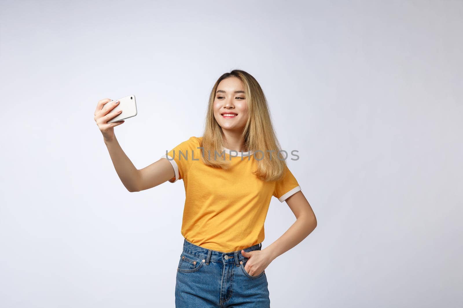 Close-up of young Asian beautiful woman taking selfie. Isolated white background.Beauty and Healthy Woman
