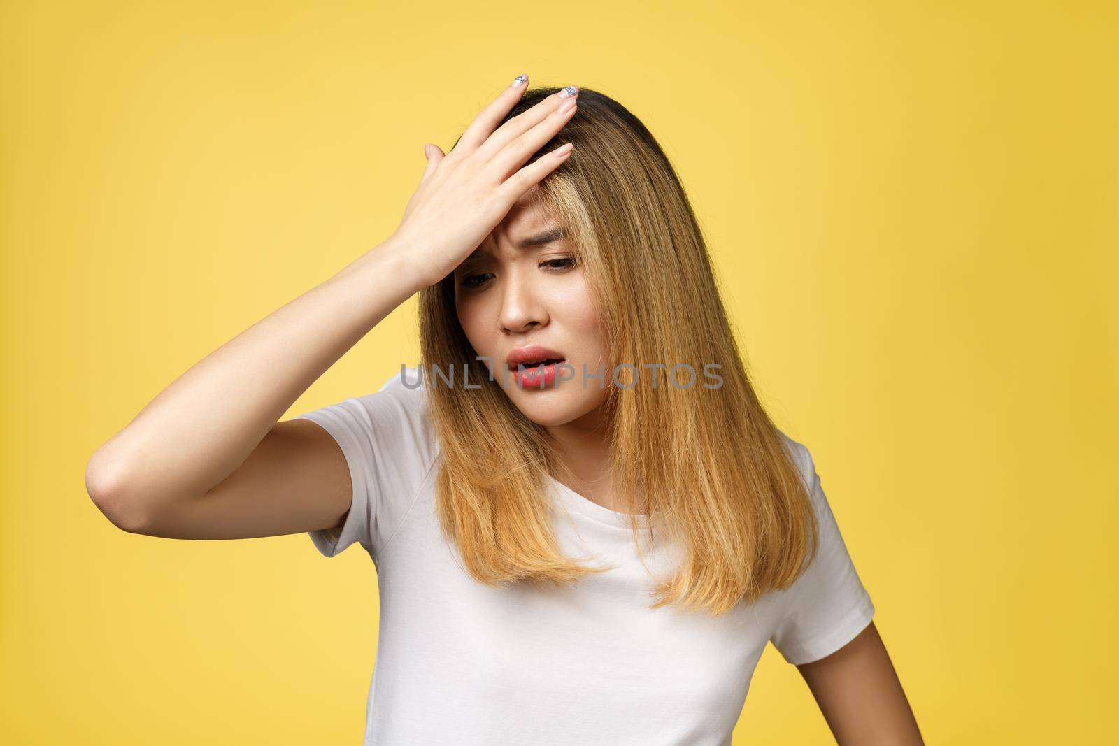 Surprised young asian woman face isolate over yellow background