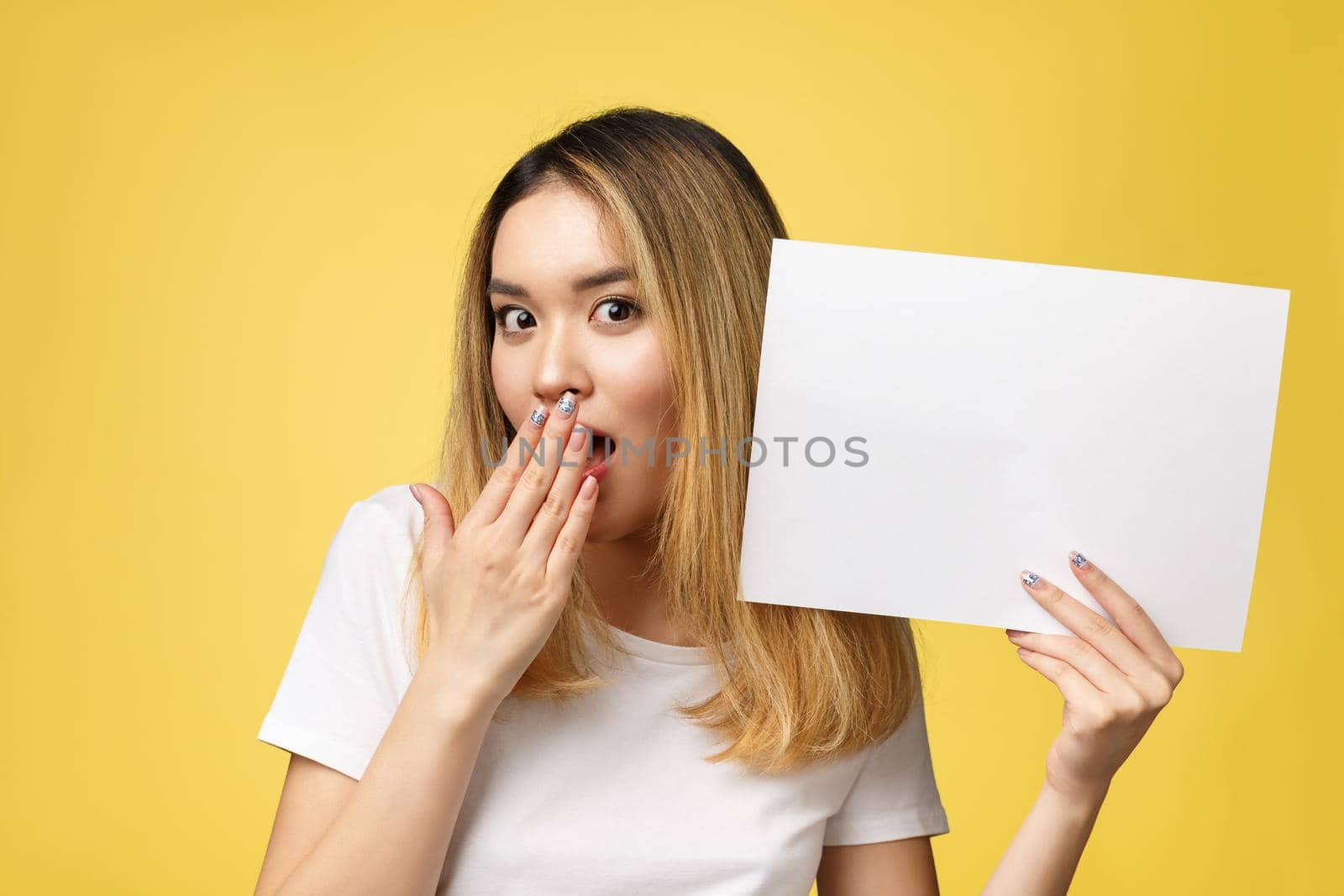 Attractive young beautiful Asian student woman holding blank white paper. by Benzoix