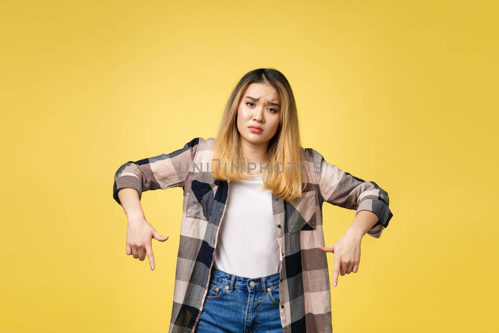 young attractive asian woman who points to the finger with unhappy emotion