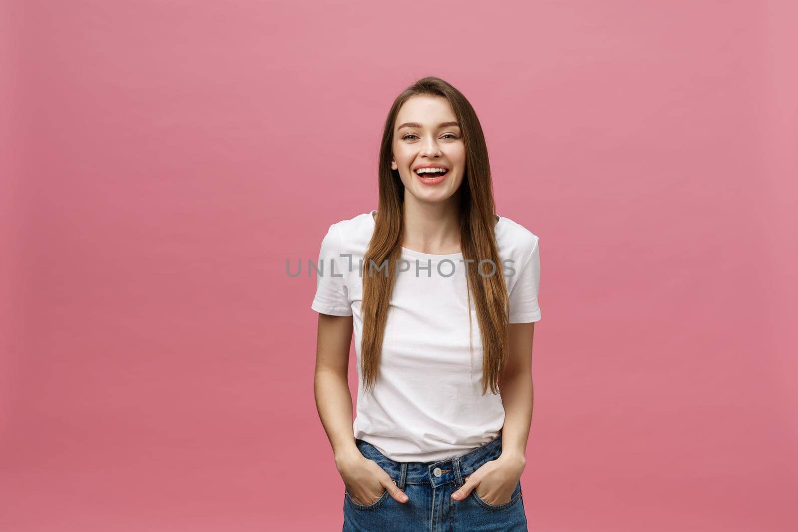 Surprised happy beautiful woman looking in excitement. Isolate over pink background and copy space