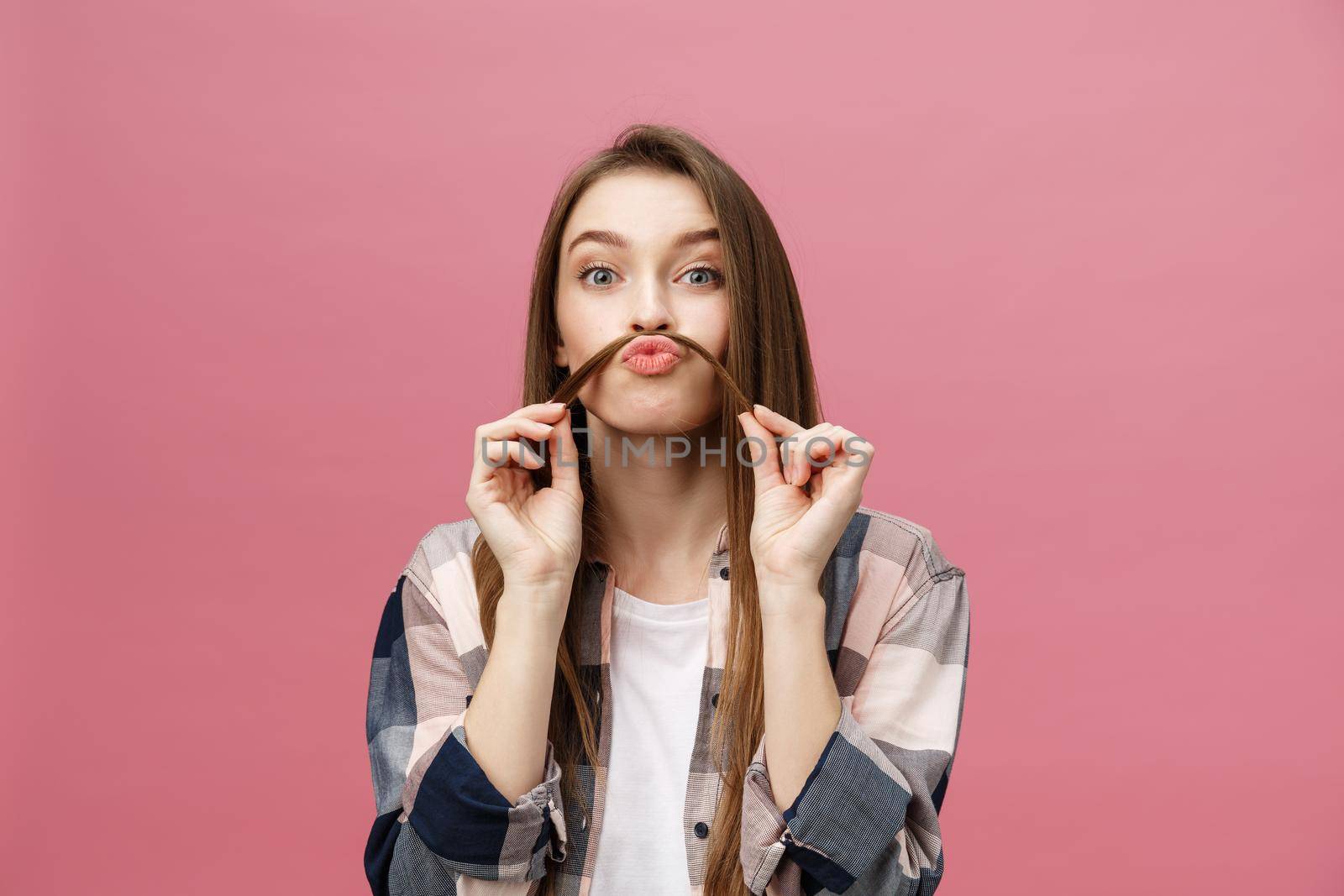 Portrait of crazy adorable young woman playing with her hairs. emotional girl isolated on white background.