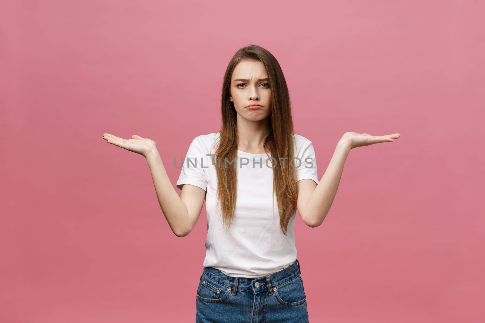 Young beautiful woman Pointing hand to the side showing advertisement, serious and calm face.