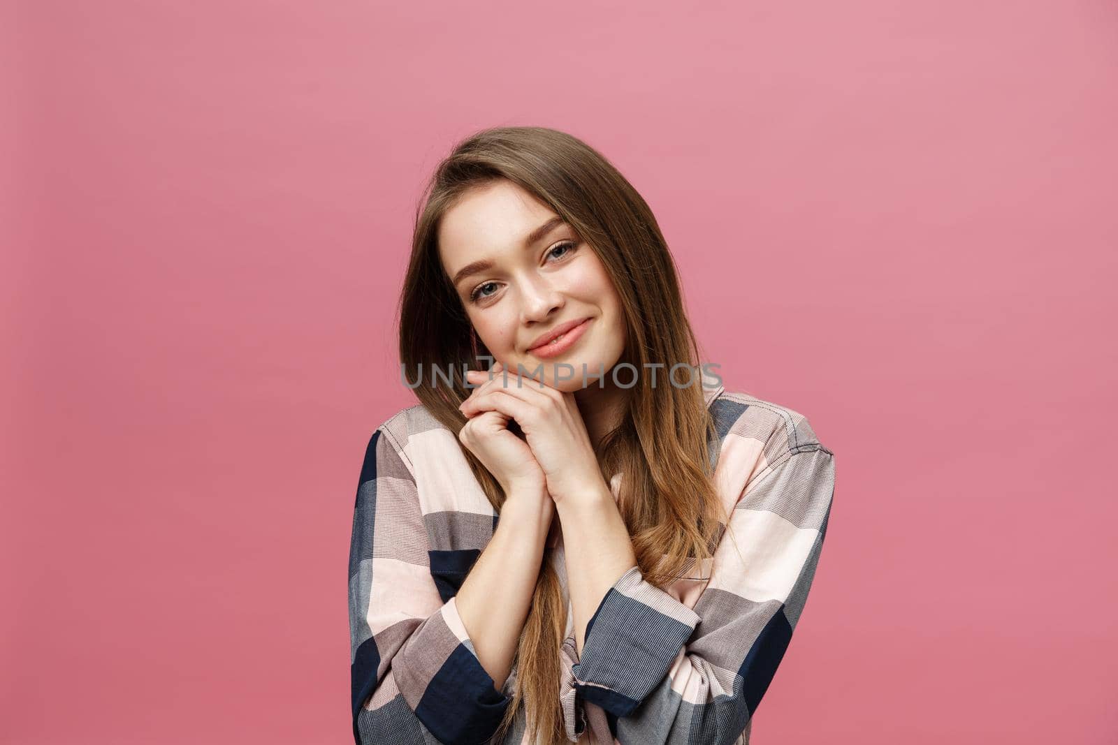 Portrait of beautiful brunette caucasian woman in pink studio.