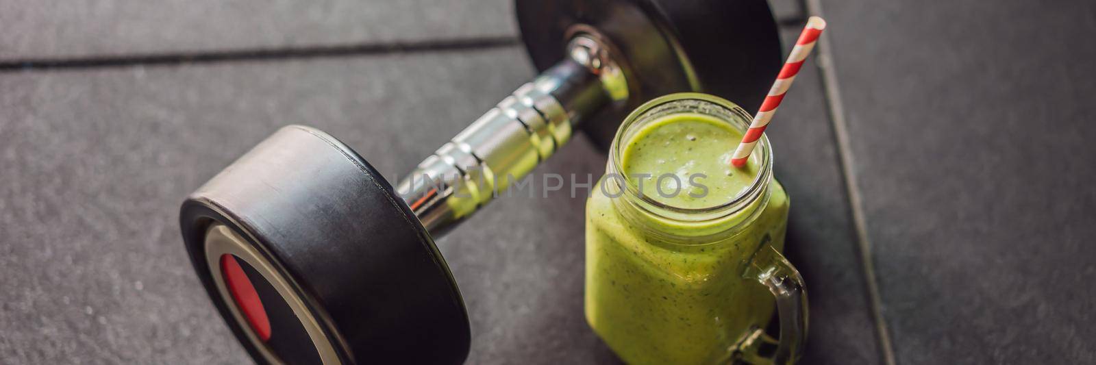 Green smoothies and dumbbells in the gym. BANNER, LONG FORMAT