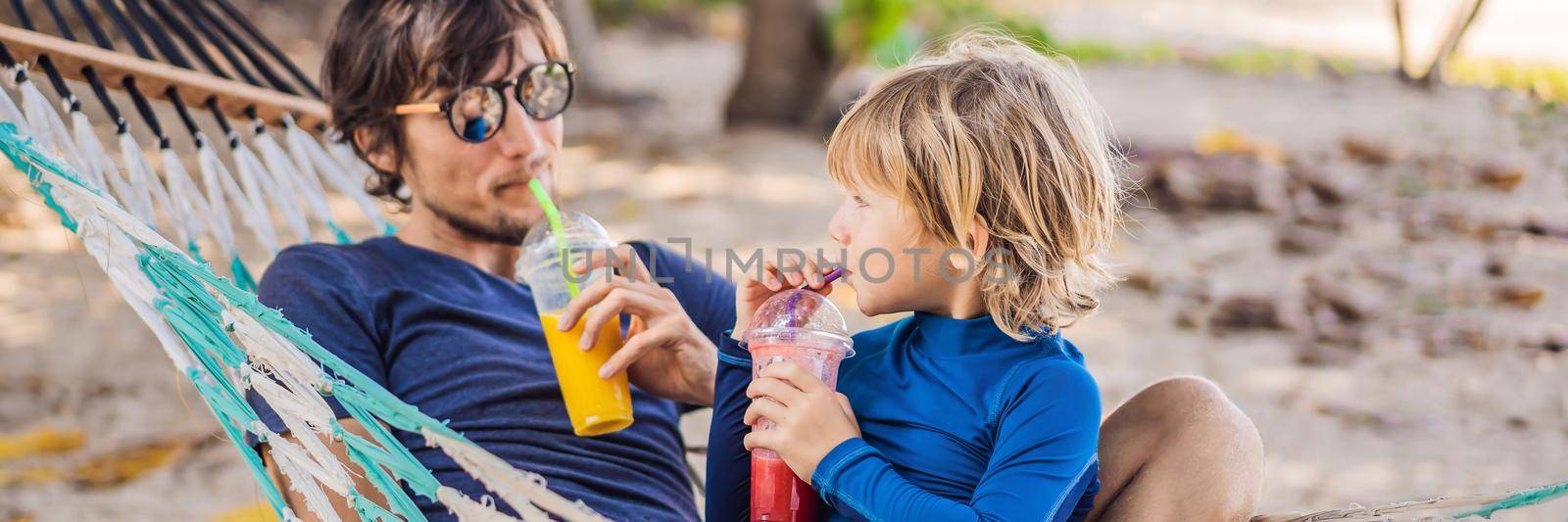 Dad and son having fun in a hammock with a drinks. BANNER, LONG FORMAT