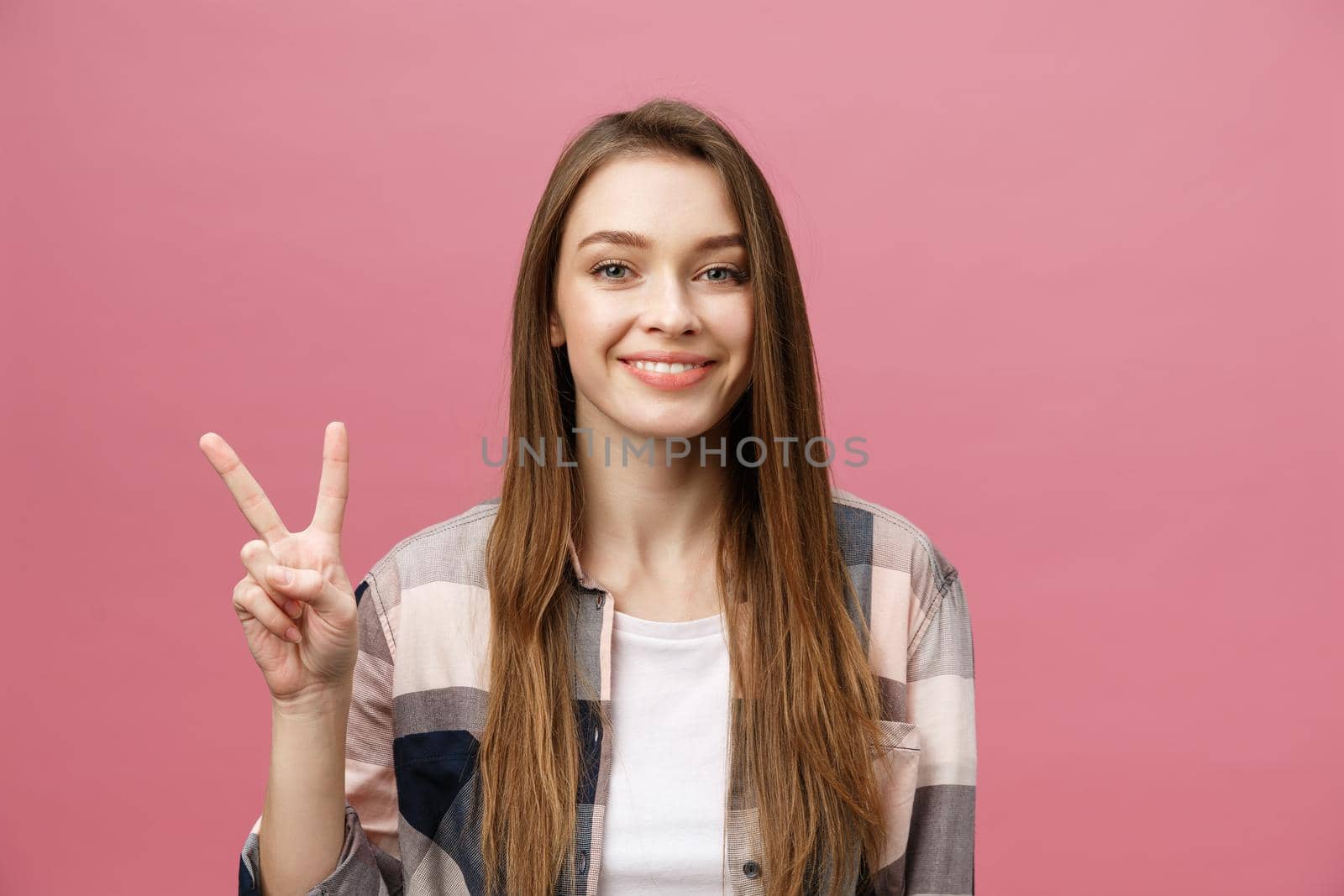 Young caucasian woman over isolated background smiling looking to the camera showing fingers doing victory sign. Number two by Benzoix