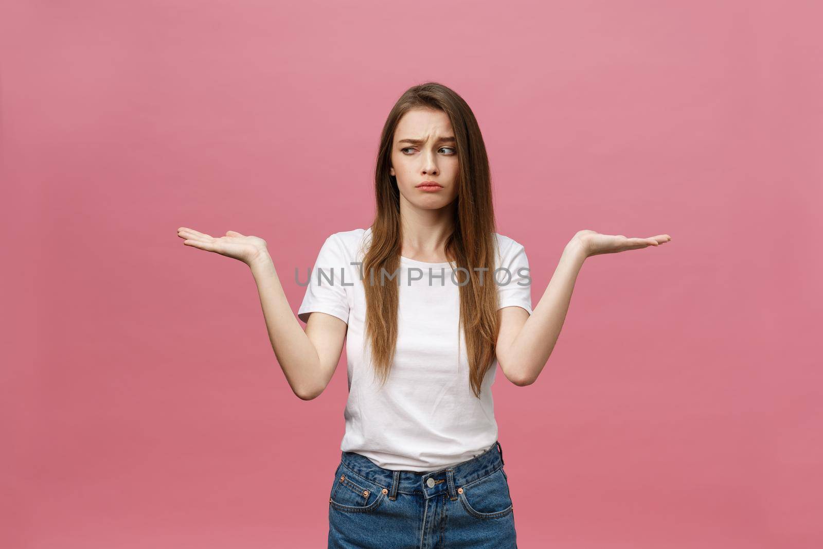 Young beautiful woman Pointing hand to the side showing advertisement, serious and calm face by Benzoix