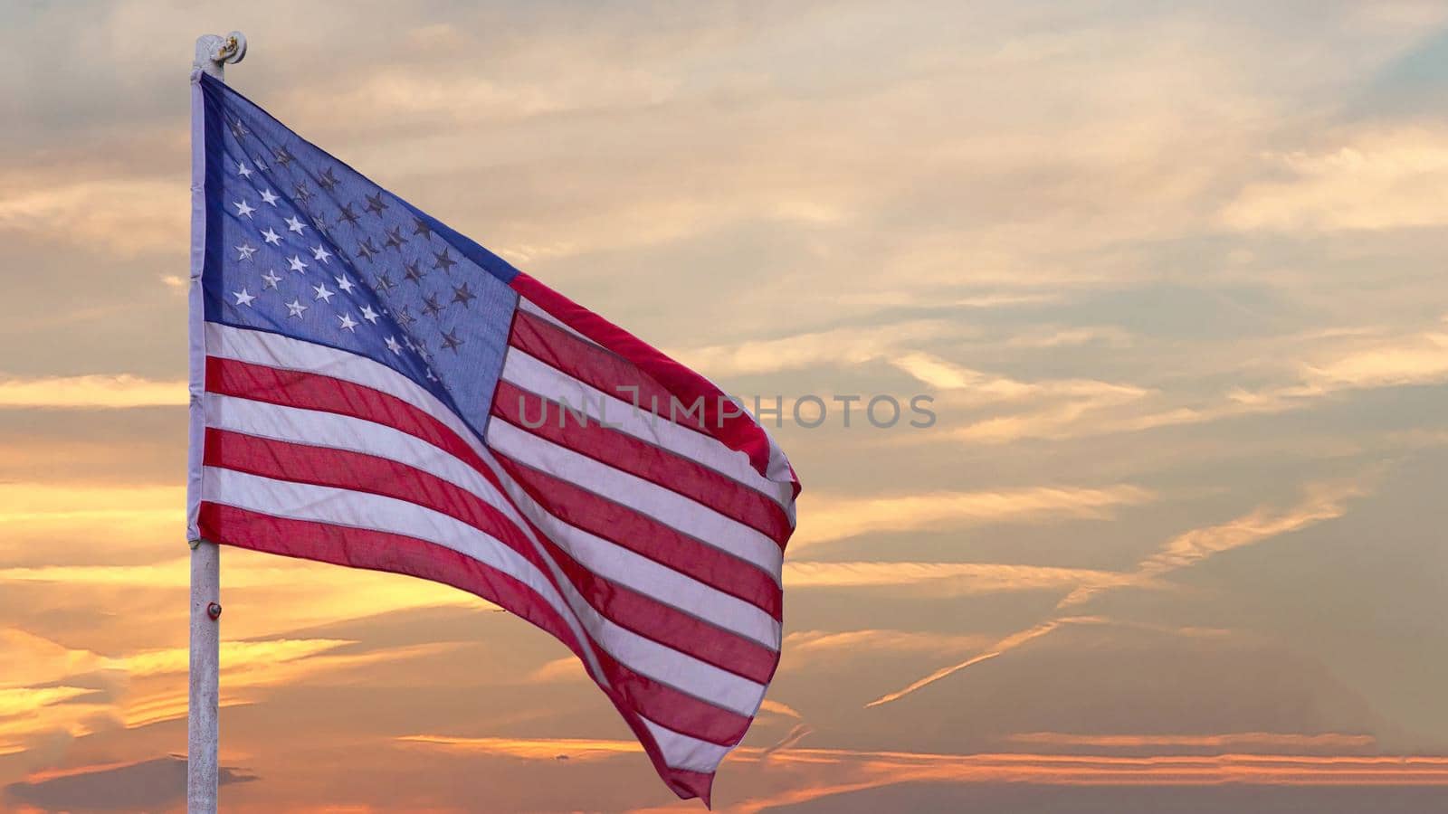illustration of American Flag waving in sky backdrop by Andelov13