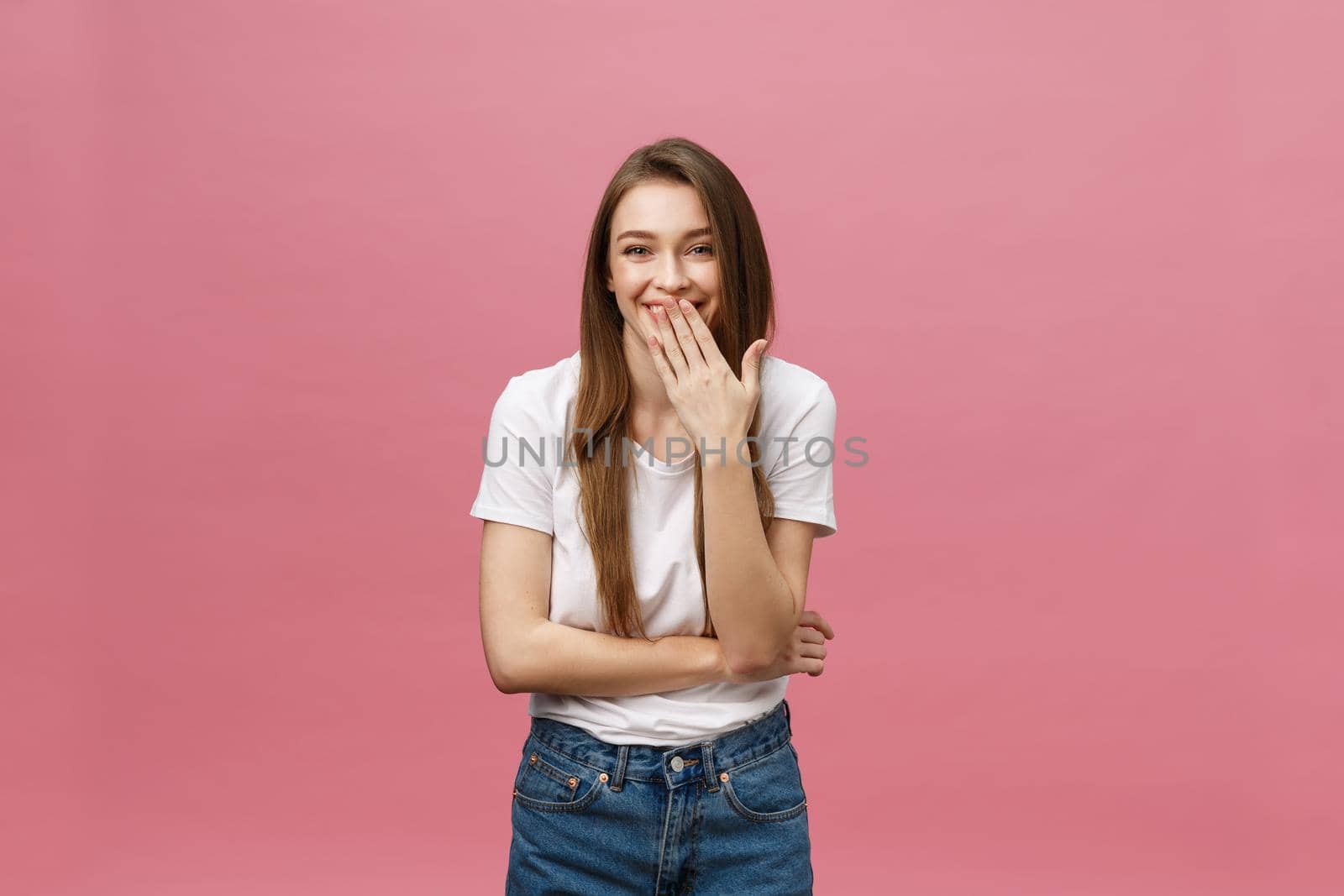 Surprised happy beautiful woman looking in excitement. Isolate over pink background and copy space