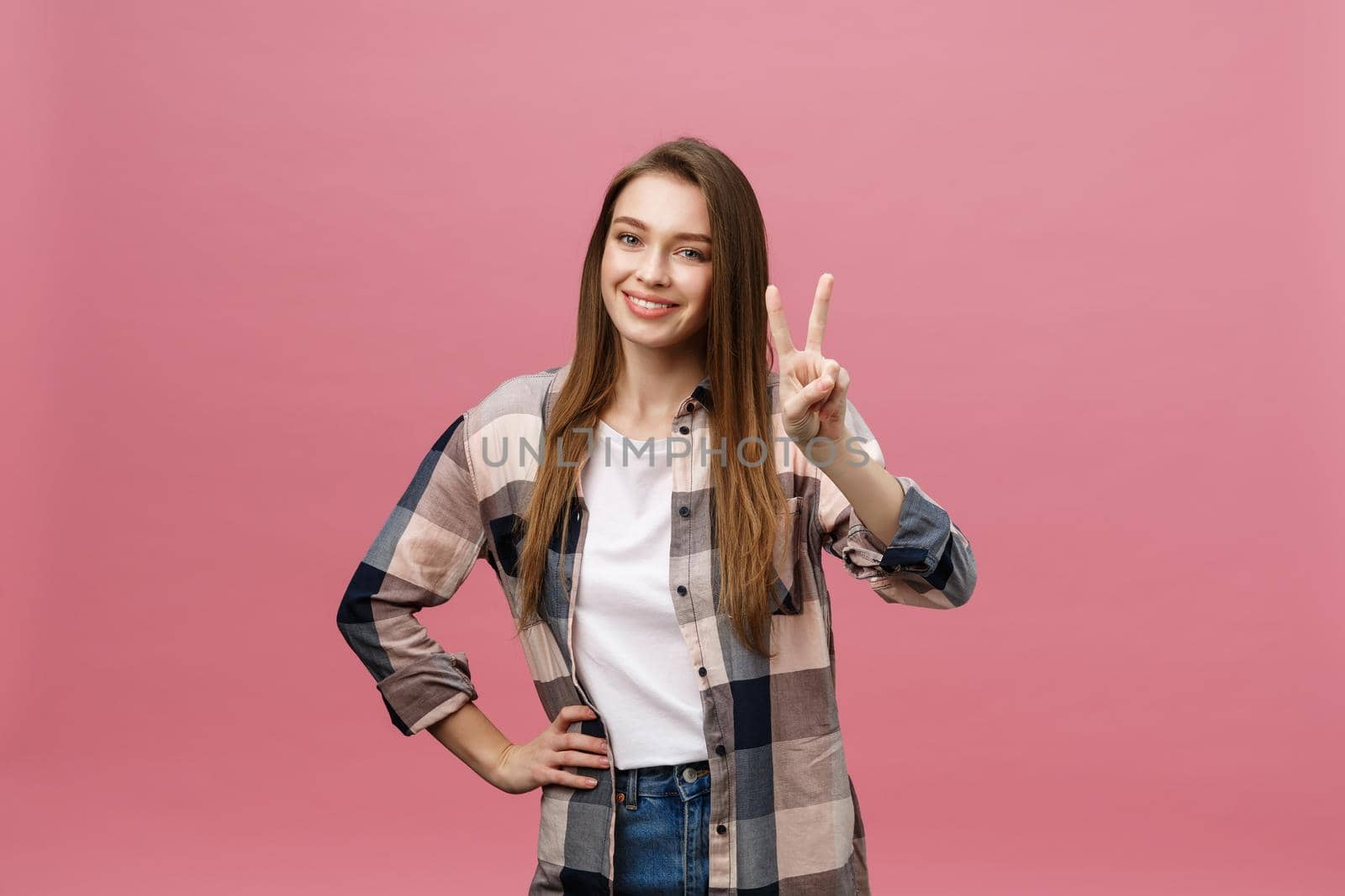 Young caucasian woman over isolated background smiling looking to the camera showing fingers doing victory sign. Number two by Benzoix