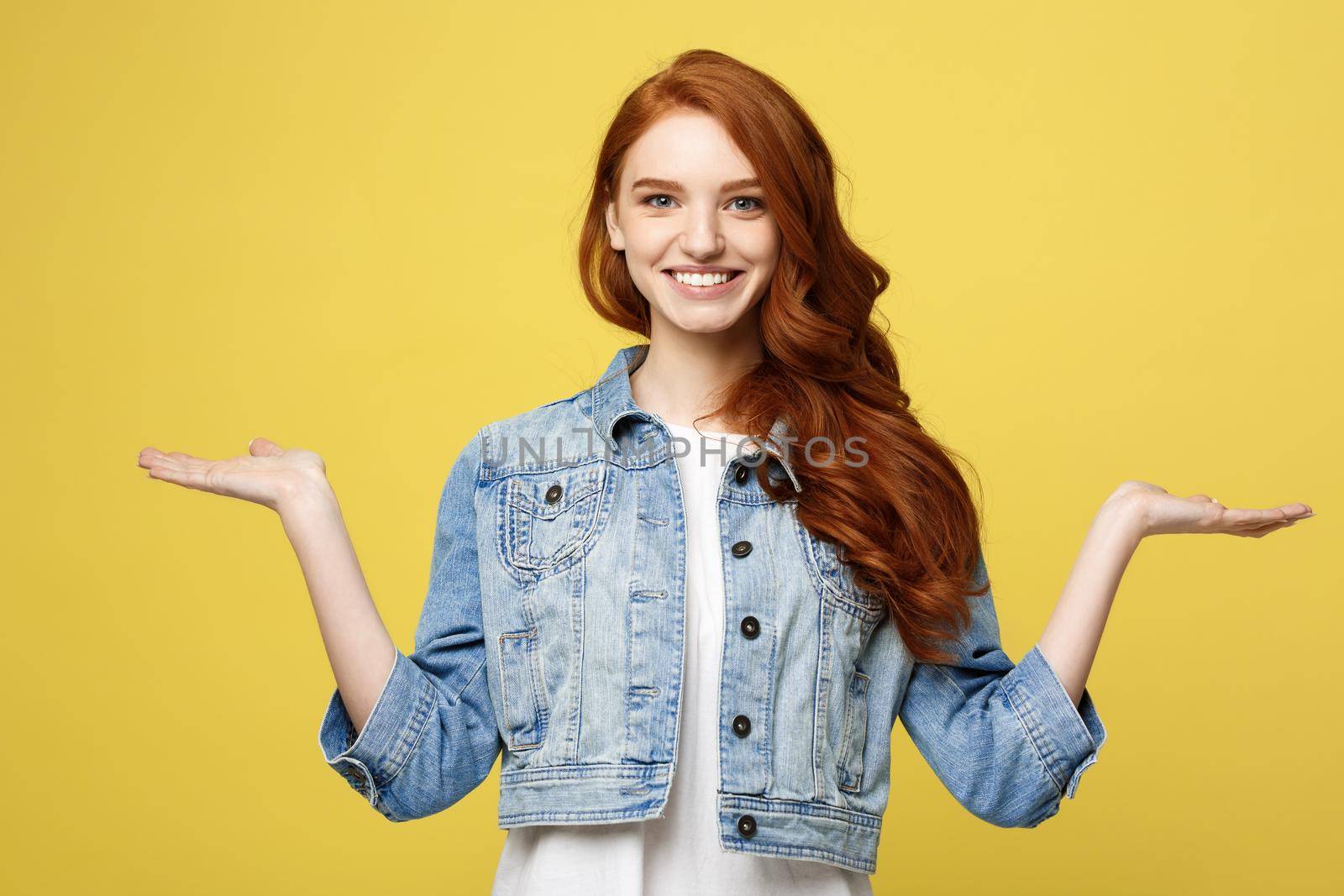 Lifestyle Concept: Surprised young woman with hand on side over golden yellow background. Looking at camera