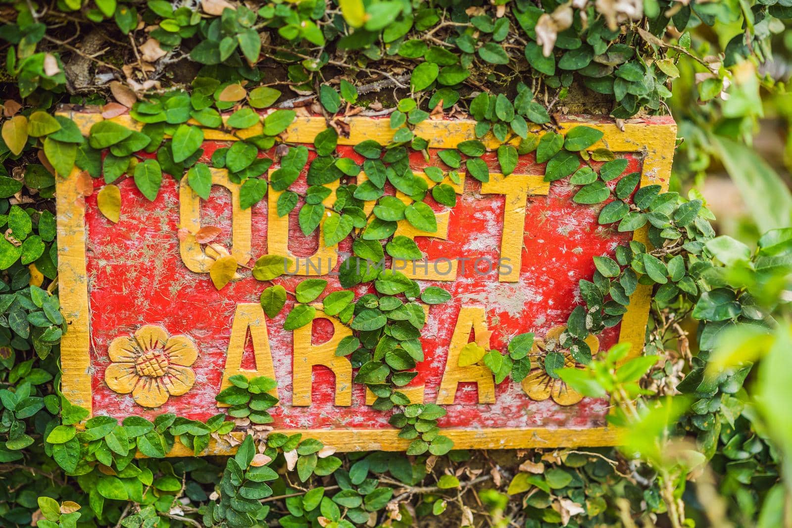 A sign QUIET AREA in a quiet corner of the garden.