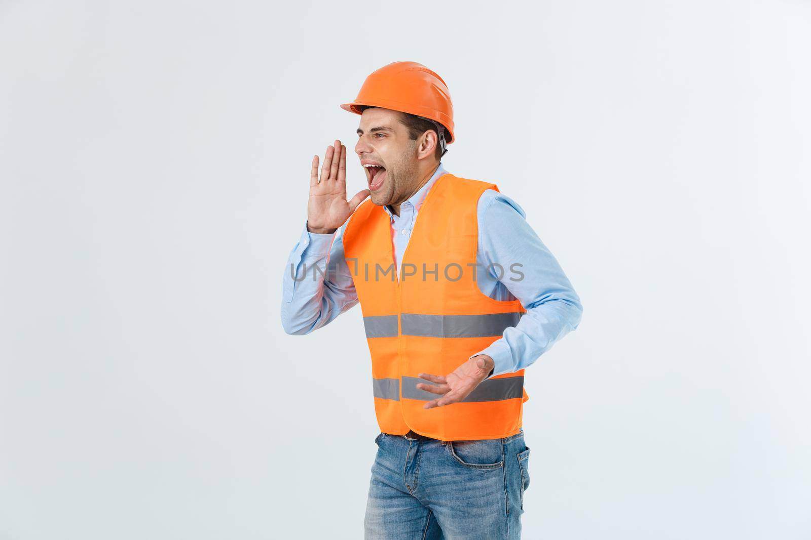 Angry engineer with angry face emotion shouting at someone raising his both hands, isolated on a white background