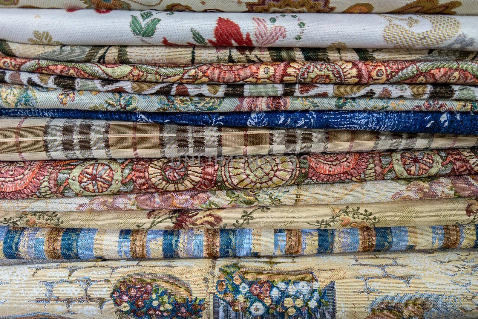 stack of colored fabric with different patterns, close-up full-frame background