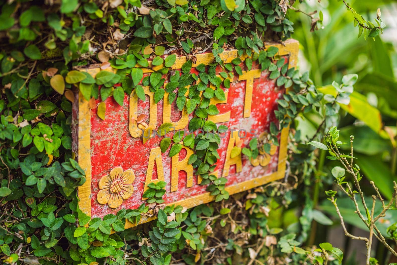A sign QUIET AREA in a quiet corner of the garden.