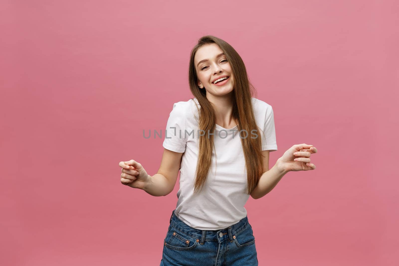 Surprised happy beautiful woman looking in excitement. Isolate over pink background and copy space. by Benzoix