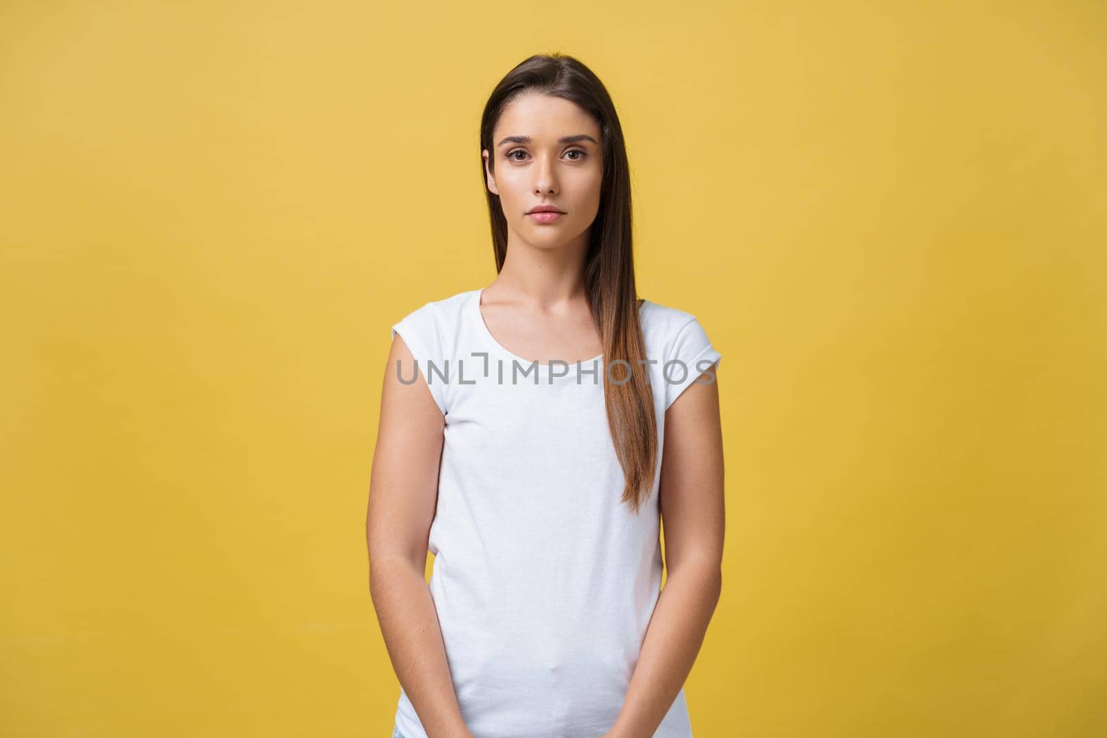 Portrait of young teenage girl with healthy skin wearing striped top looking at camera with serious or pensive expression. Caucasian woman model with beautiful face posing indoors by Benzoix