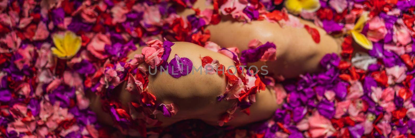 Attractive Young woman in bath with petals of tropical flowers and aroma oils. Spa treatments for skin rejuvenation. Alluring woman in Spa salon. Girl relaxing in bathtub with flower petals. Luxury BANNER, LONG FORMAT by galitskaya