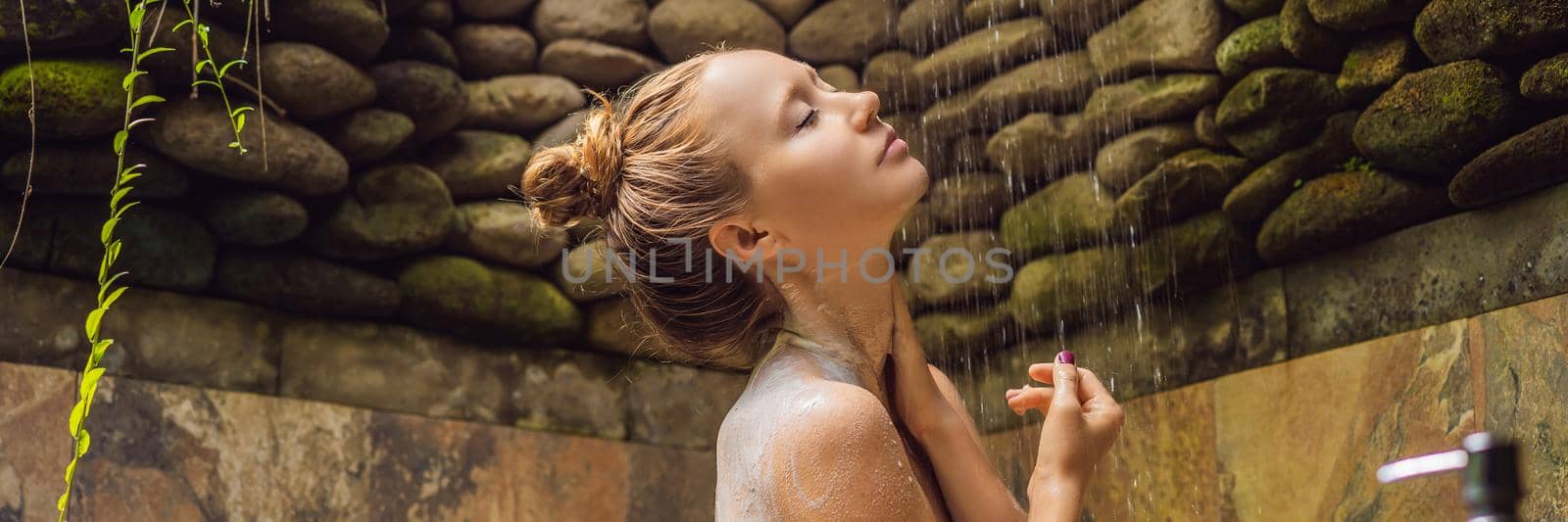 Back view of beautiful naked young woman taking shower in bathroom. BANNER, LONG FORMAT