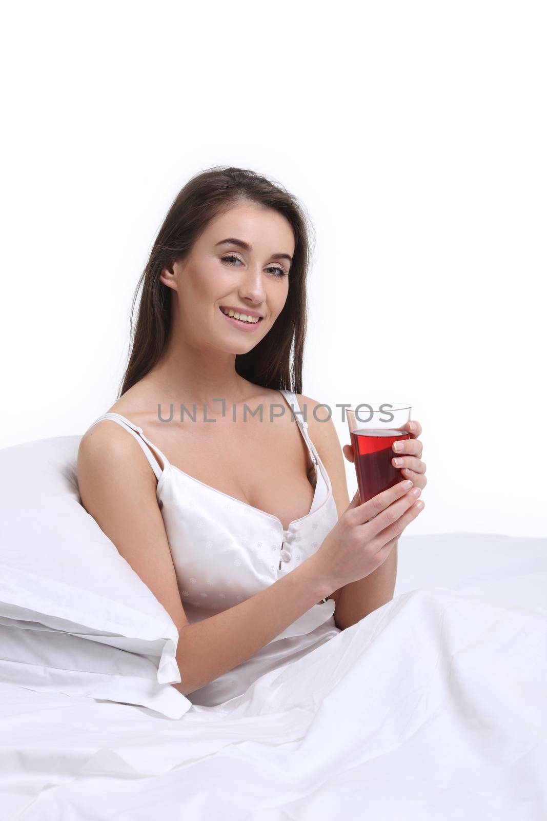 Pretty girl drinking in bed