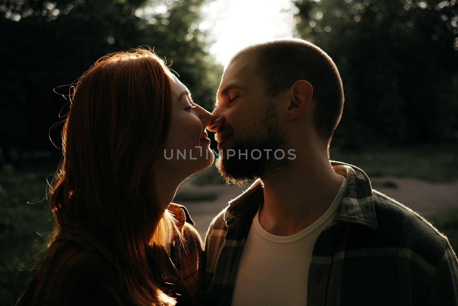 lovers kiss at sunset in the backlight by Symonenko