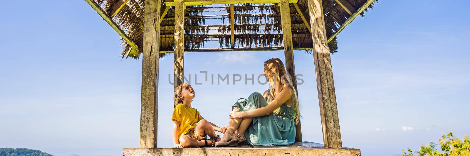 Mom and son in a gazebo in Bali. Traveling with kids concept. Kids Friendly places BANNER, LONG FORMAT by galitskaya