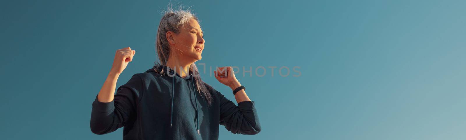 Woman training on warm day by the coast by Yaroslav_astakhov