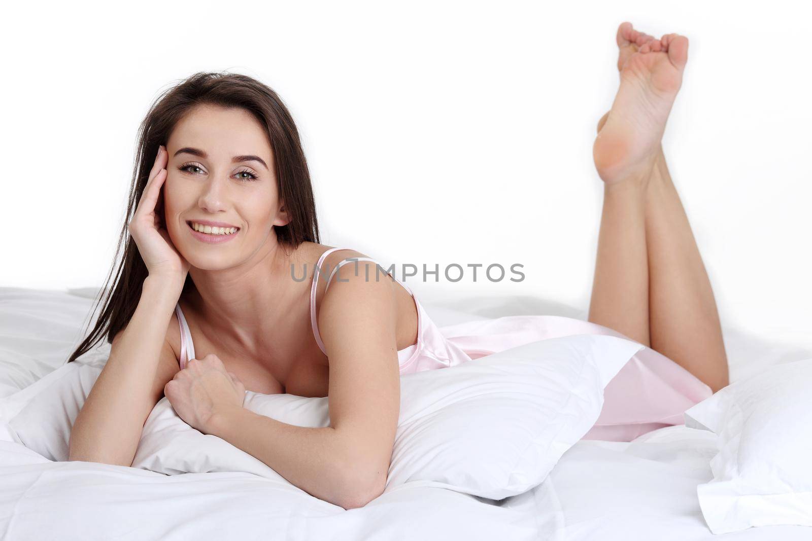 Young beautiful woman waking up in her bed fully rested. Woman in bed after wake up. Healthy lifestyle.