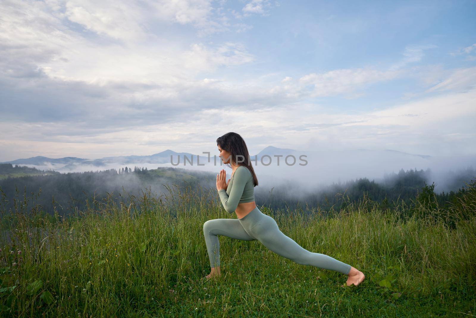 Active woman in sport clothes enjoying outdoors yoga by SerhiiBobyk