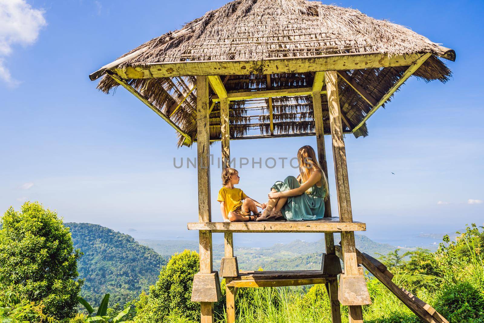 Mom and son in a gazebo in Bali. Traveling with kids concept. Kids Friendly places.