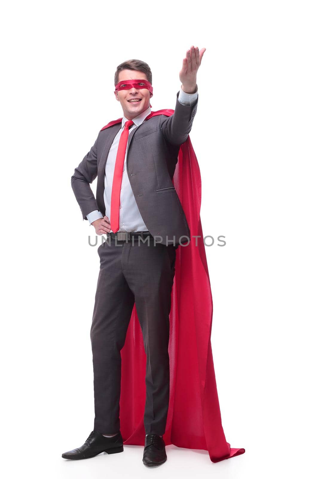 in full growth. smiling superhero businessman pointing to copy space. isolated on white