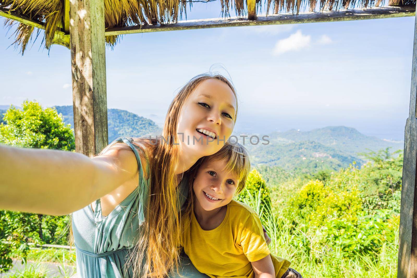 Mom and son in a gazebo in Bali. Traveling with kids concept. Kids Friendly places by galitskaya