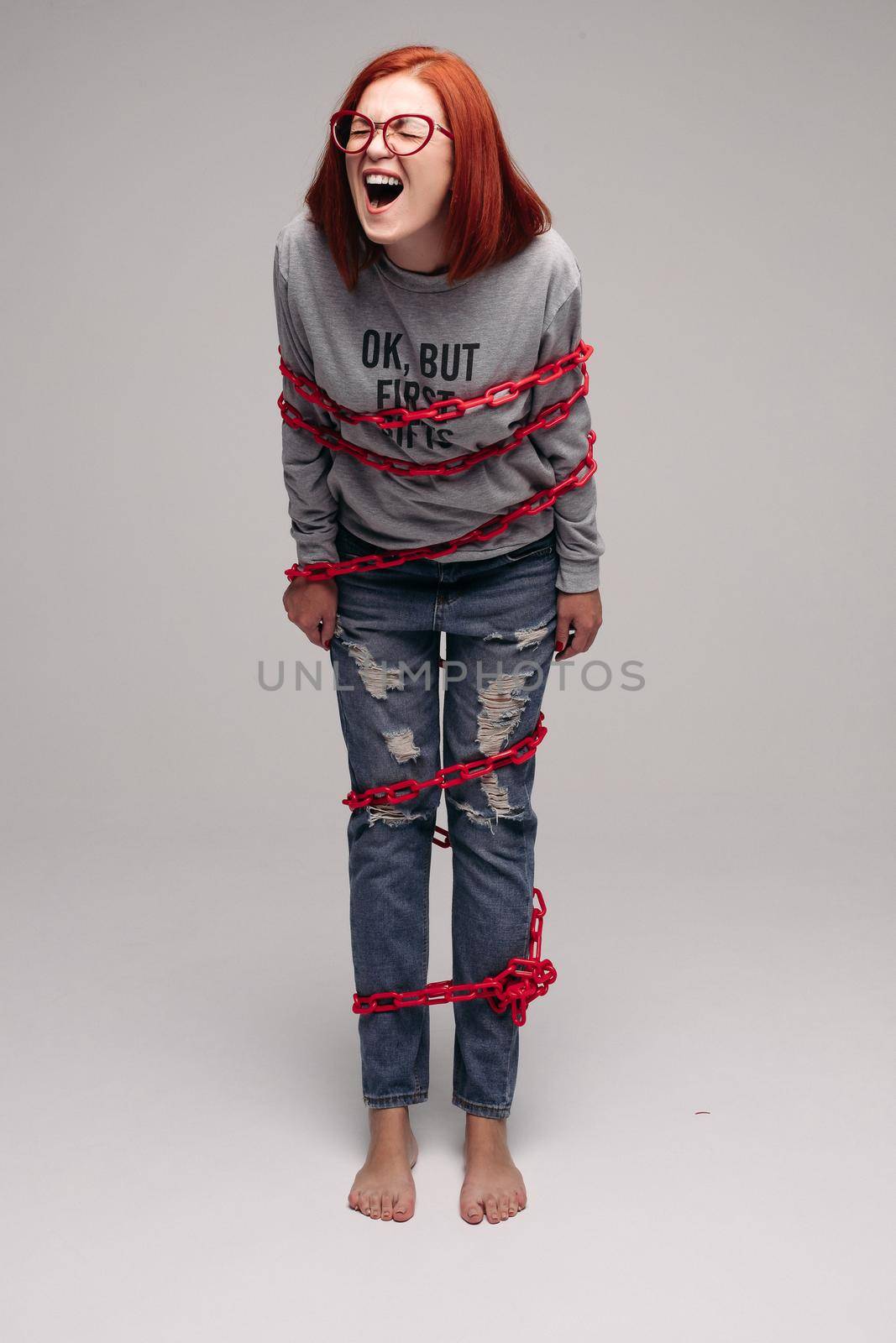 girl entangled in a chain,A red-haired woman with brown hair tries to get rid of the chain by StudioLucky