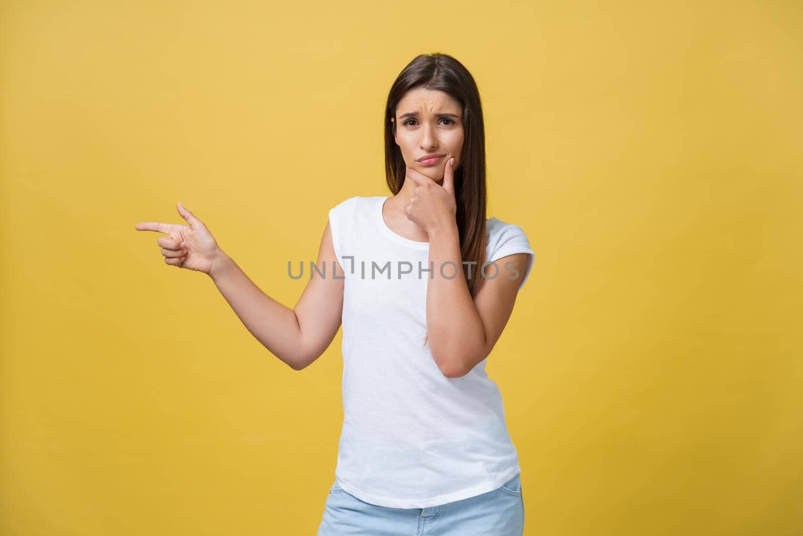 Closeup portrait of young pretty unhappy, serious woman pointing at someone as if to say you did something wrong, bad mistake isolated on yellow background. Negative emotion, facial expression feeling.