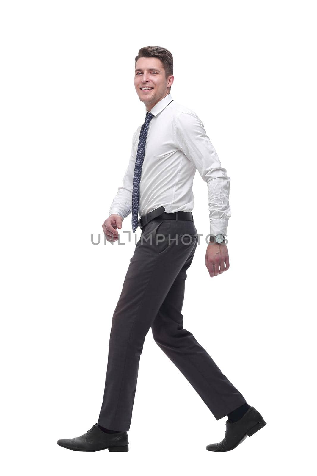 in full growth.a successful young businessman confidently goes forward. isolated on white