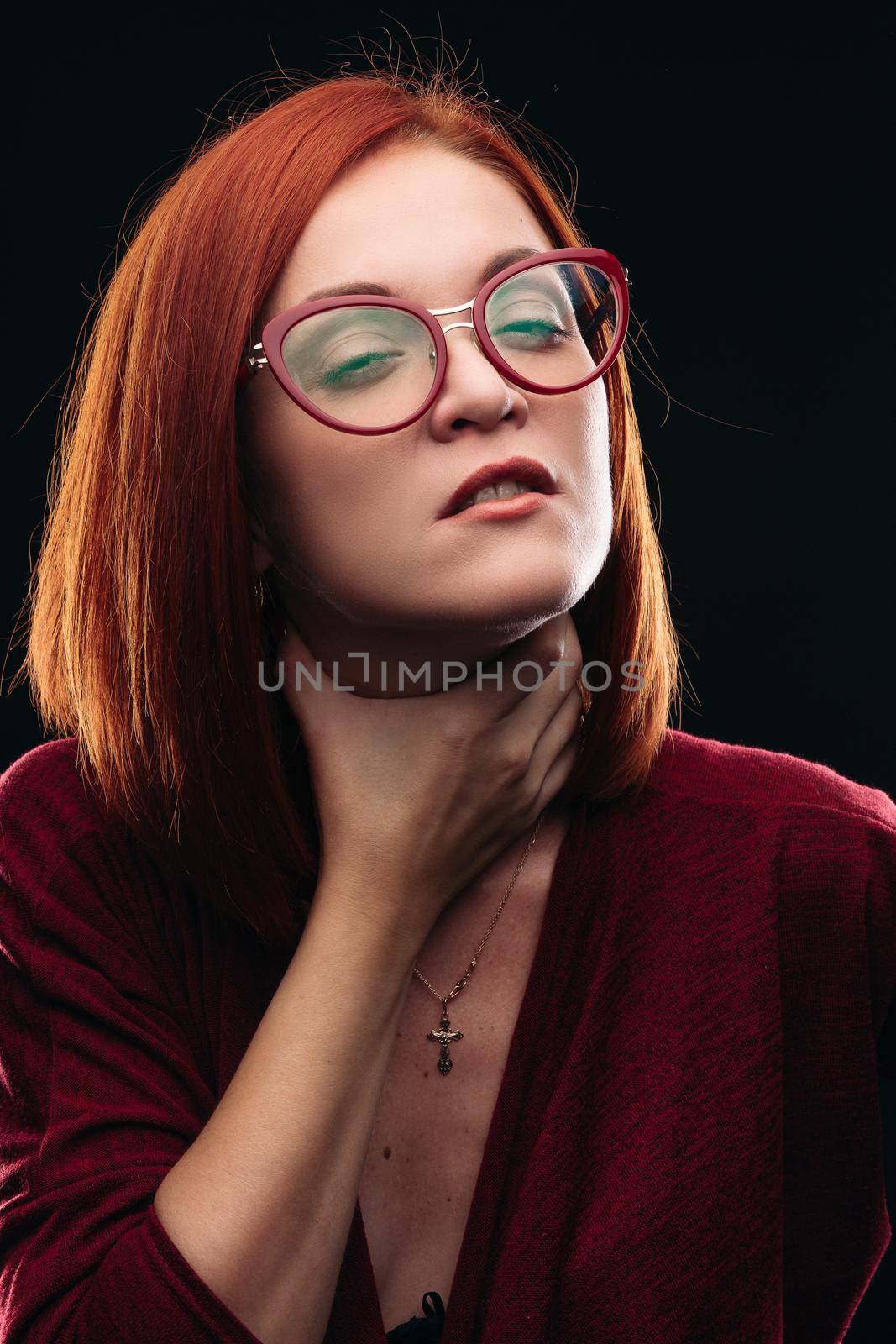 Woman in spectacles having sore throat, she holding hand on neck. by StudioLucky
