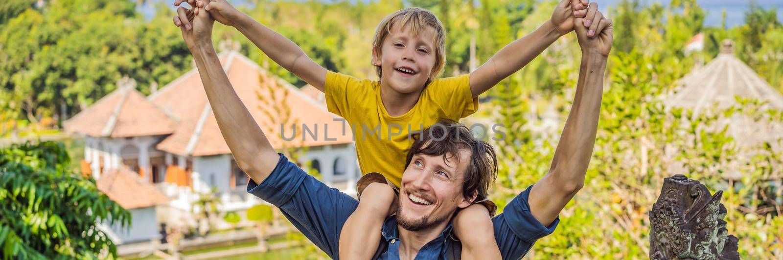 Dad and son in Water Palace Soekasada Taman Ujung Ruins on Bali Island in Indonesia. Amazing old architecture. Travel and holidays background. Traveling with kids concept. Kids Friendly places BANNER, LONG FORMAT by galitskaya