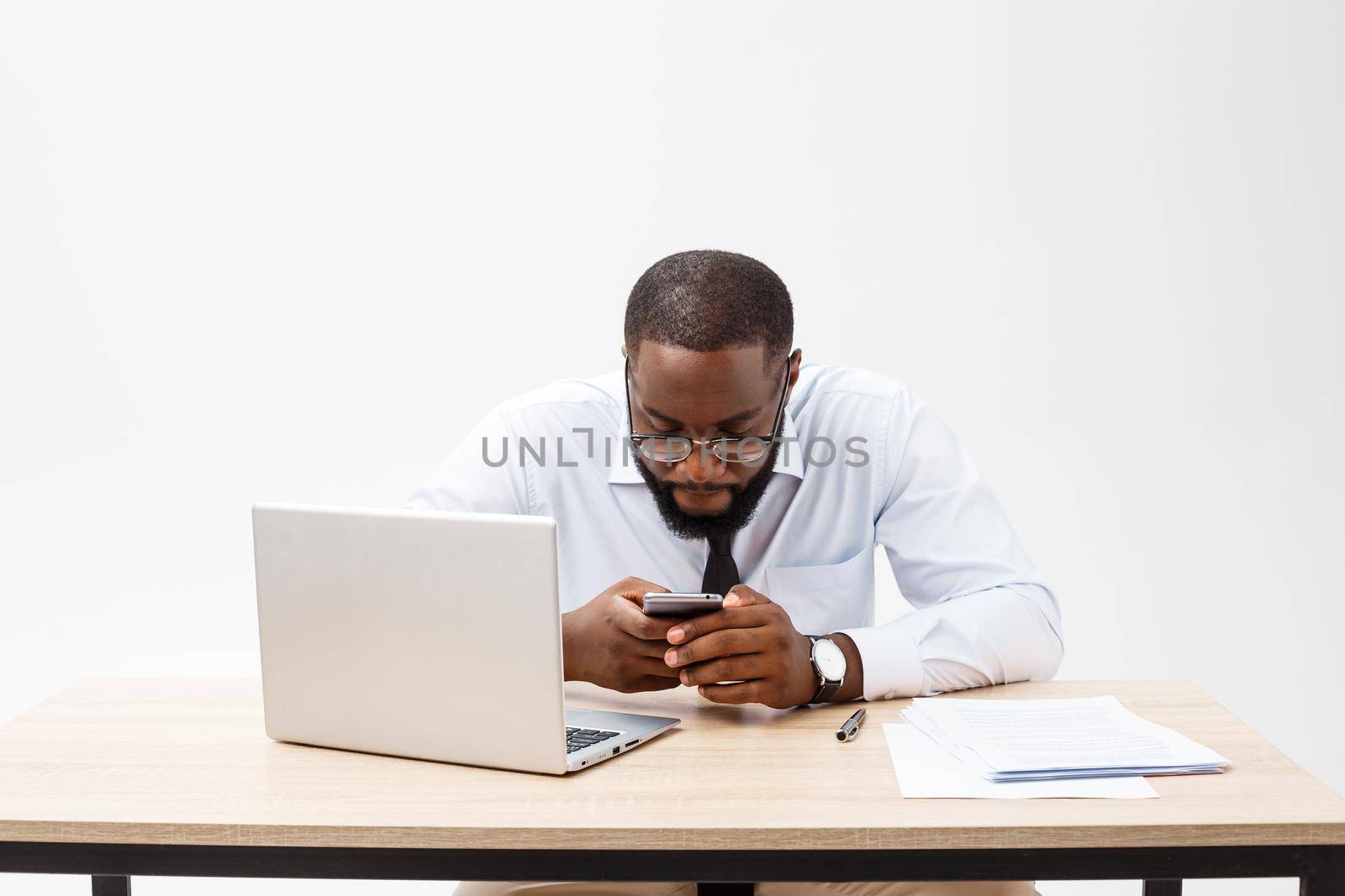 Business is his life. Cheerful young African man in formal wear and working on laptop.