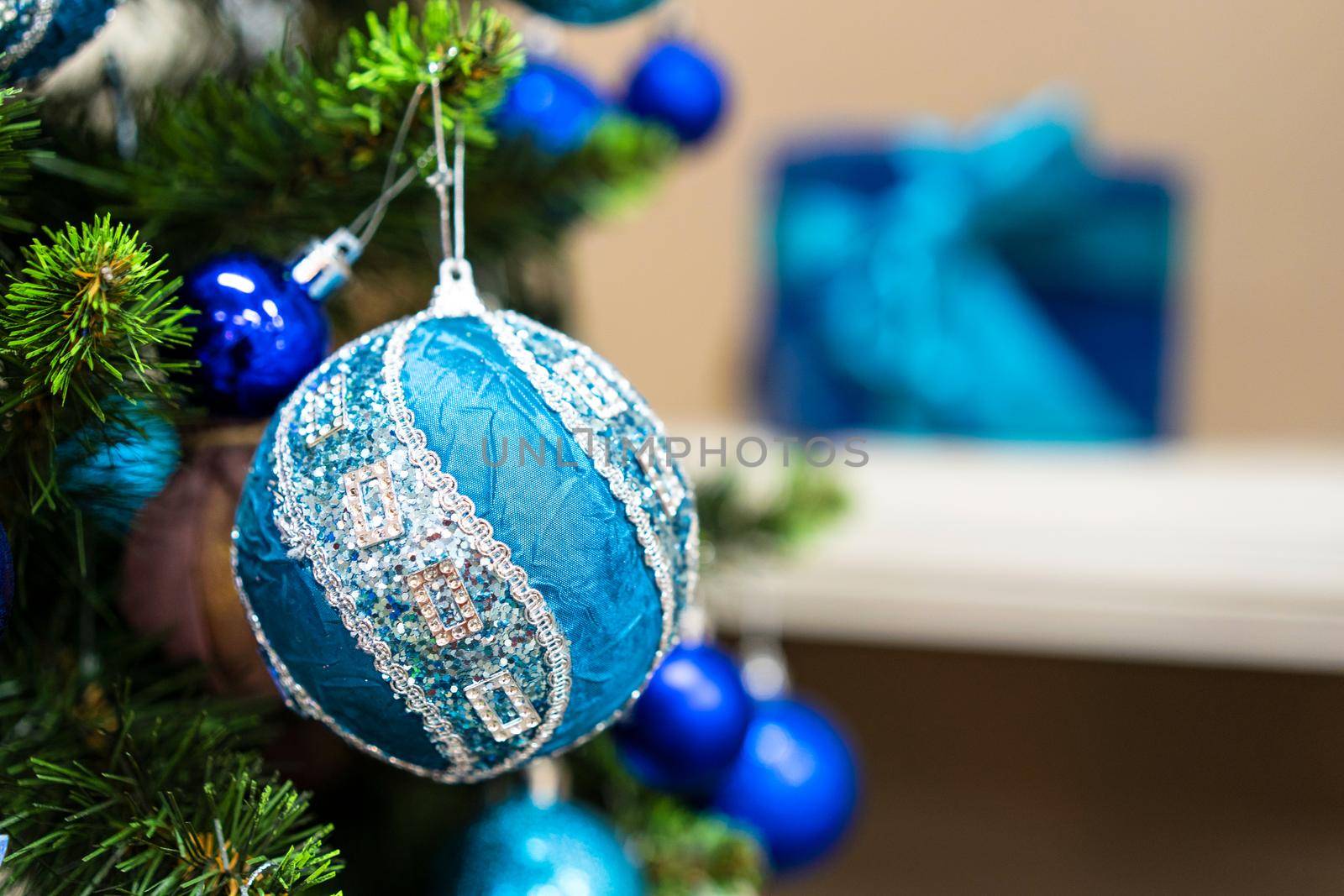 Green Christmas Tree With Beautiful White and Blue Decorations. Closed-Up shot. Big Beautiful New Year Decoration of Blue and White. Winter Season Holidays.