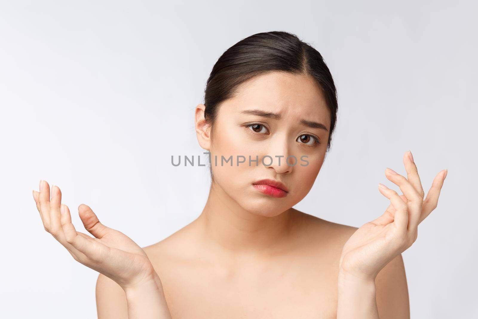 Face Skin Problem - young woman unhappy touch her skin isolated, concept for skin care, asian. by Benzoix