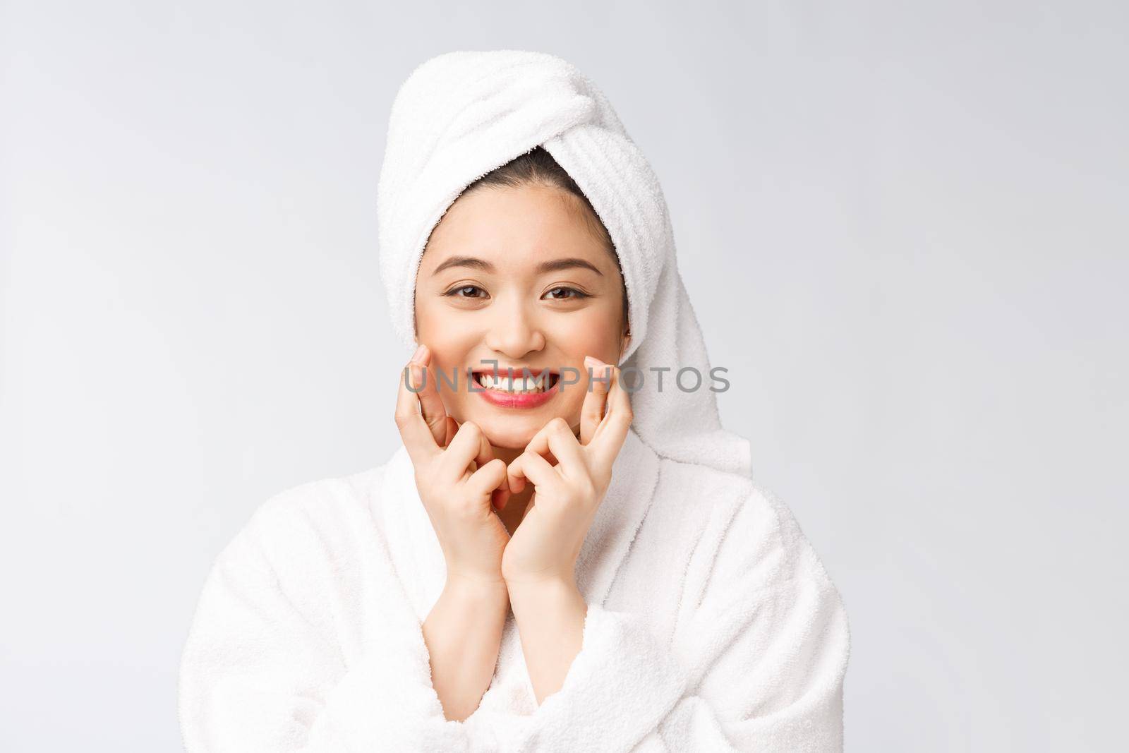 Spa skincare beauty Asian woman drying hair with towel on head after shower treatment. Beautiful multiracial young girl touching soft skin.