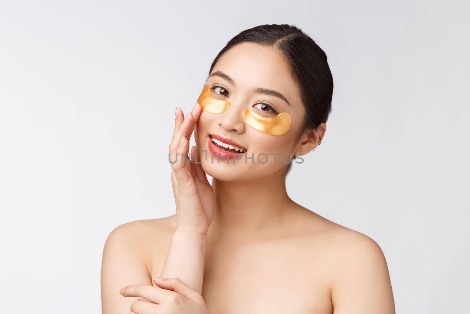Asian beauty teenager woman care her skin with gold eye masks patches under eyes by Benzoix
