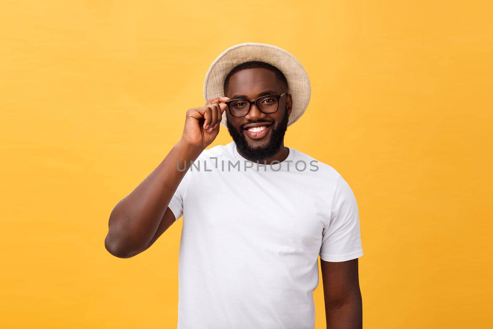 Close up portrait of young afro american shocked tourist , holding his eyewear, wearing tourist outfit, hat, with wide open eyes.