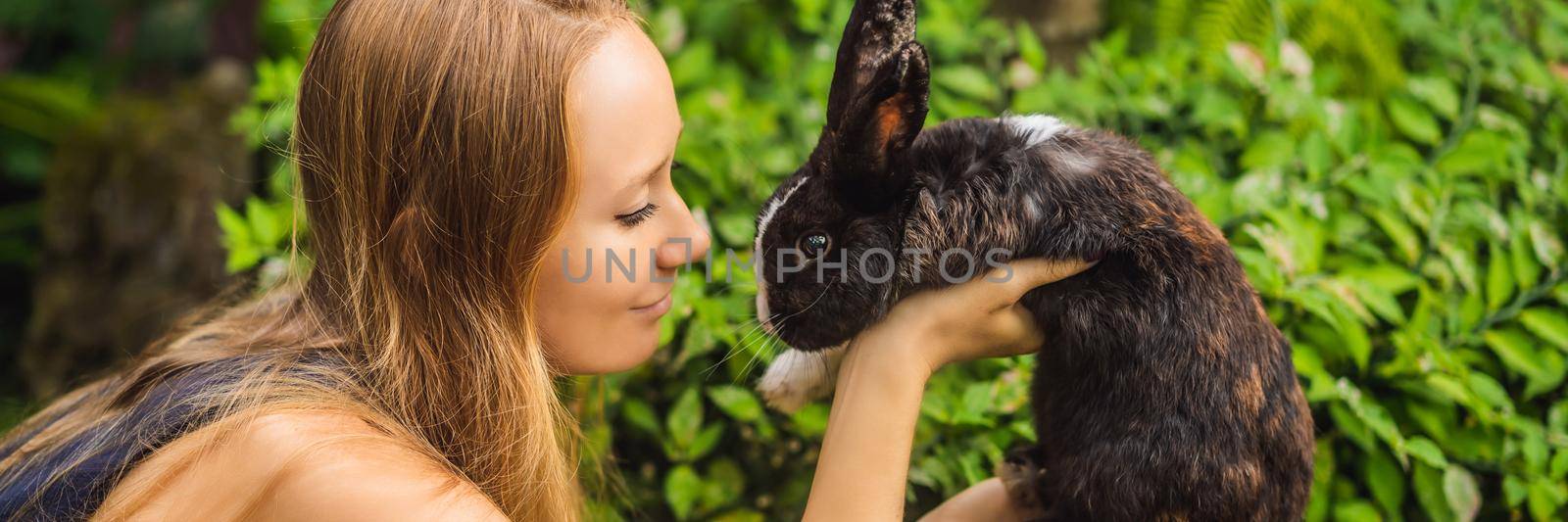 Woman holding a rabbit. Cosmetics test on rabbit animal. Cruelty free and stop animal abuse concept BANNER, LONG FORMAT by galitskaya