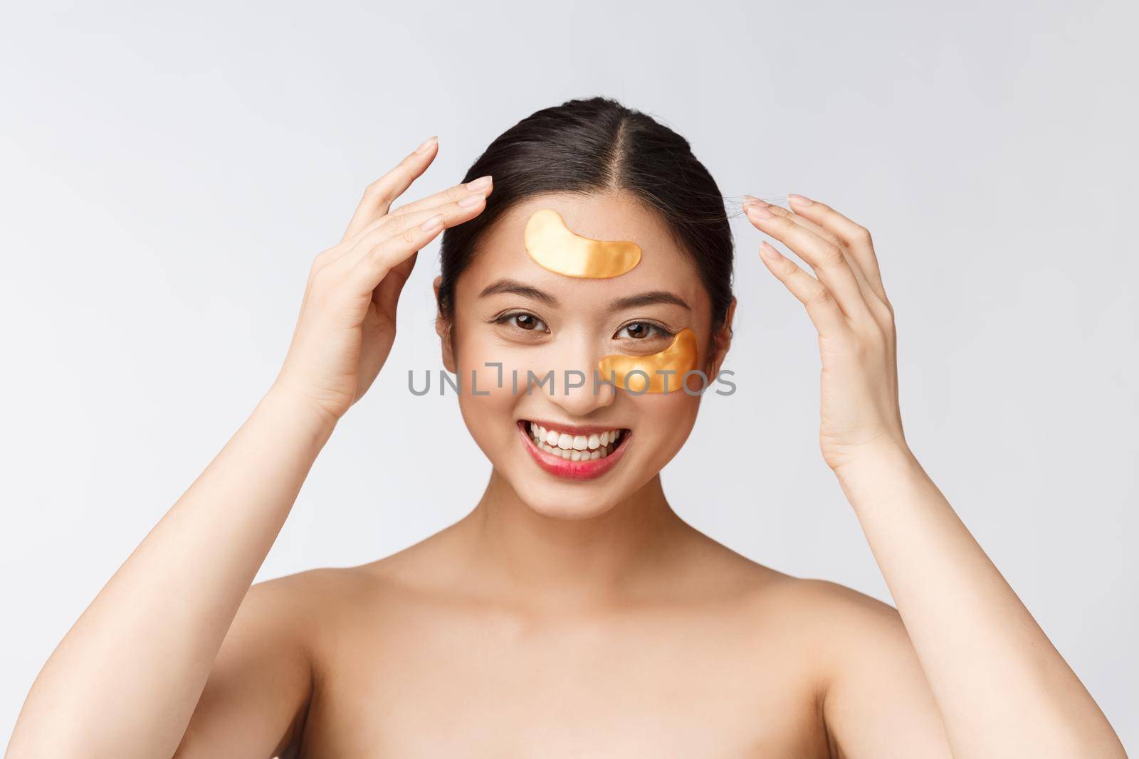 Asian beauty teenager woman care her skin with gold eye masks patches under eyes.