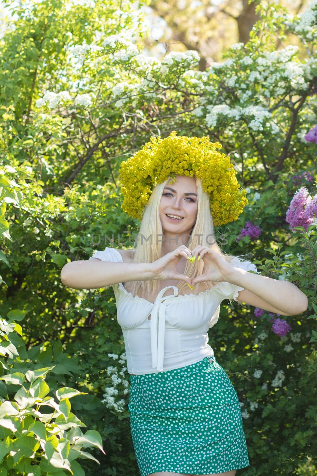Blonde woman with yellow flower wreath in springtime by Bonda