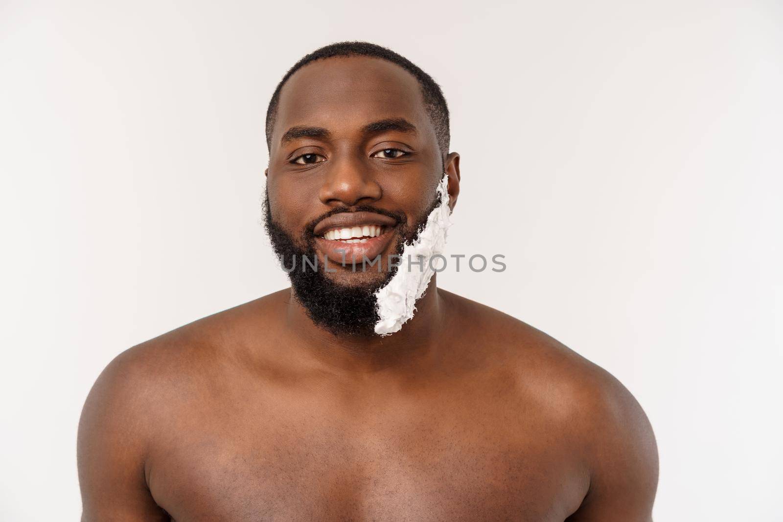 Young Afro American Man Shaving in Bathroom. Personal Morning Routine. Hygiene at Morning Concept